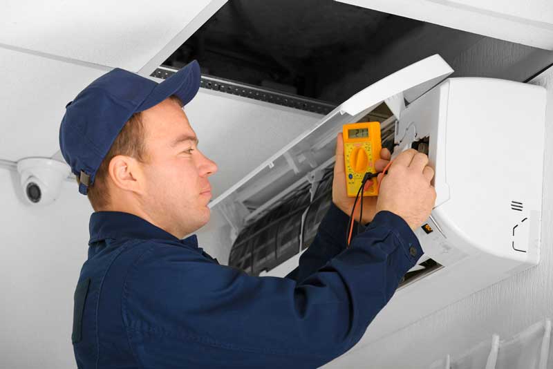 technician testing indoor part of a ductless unit 