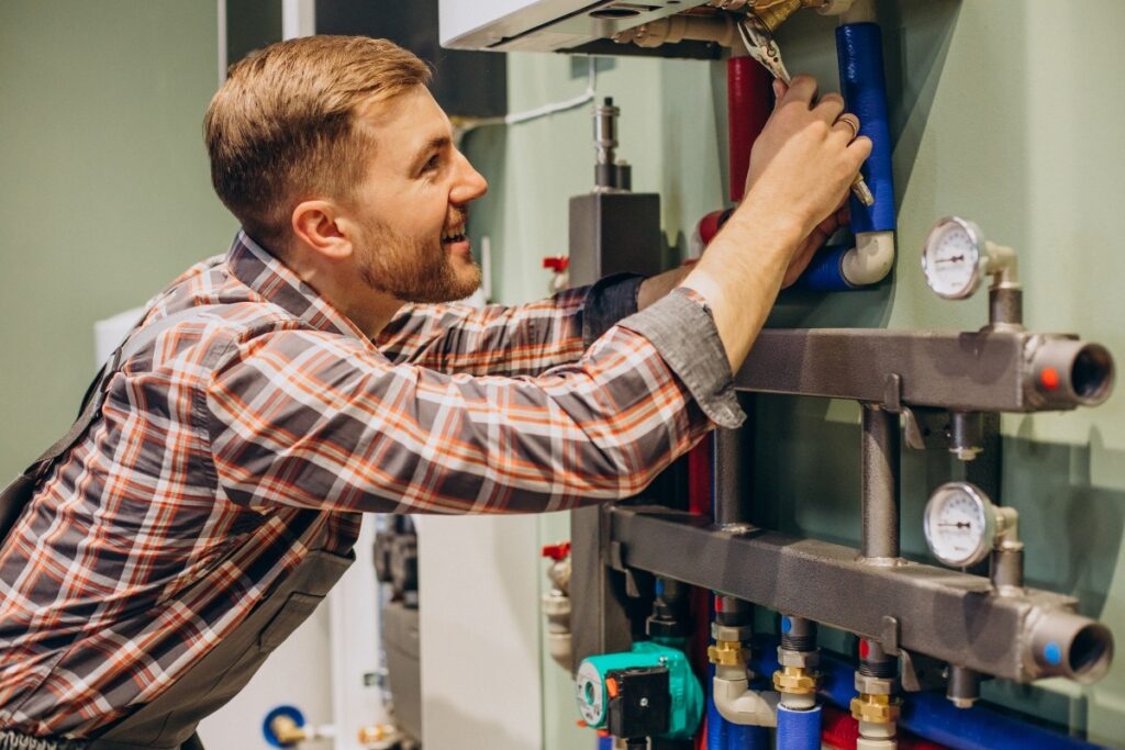 A technician performing a heating system maintenance check. 