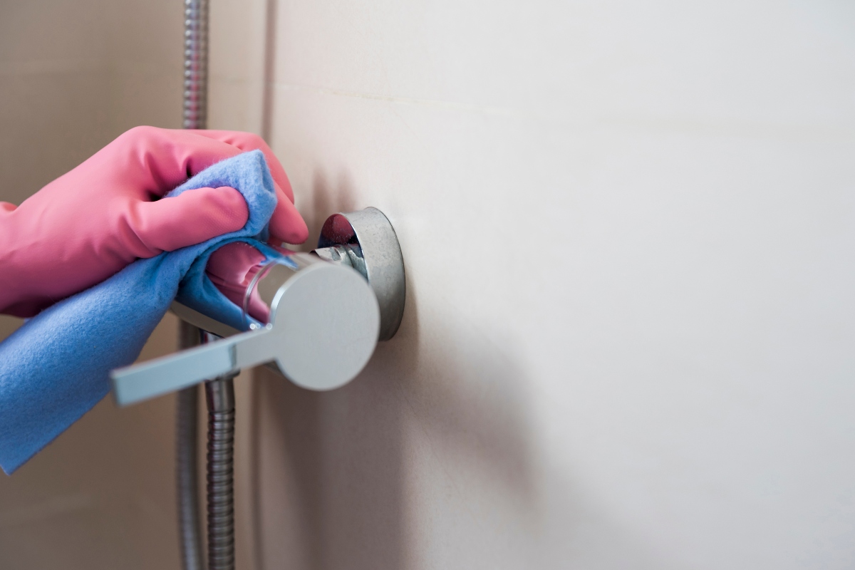 A hand cleaning limescale caused by hard water problems in Las Vegas.