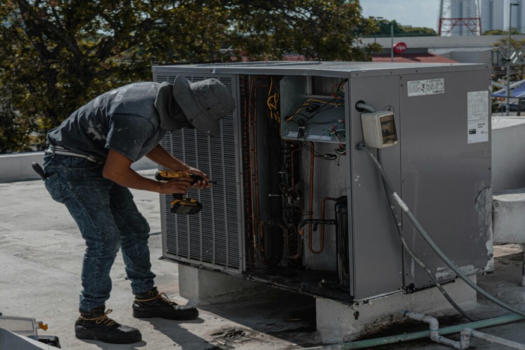 A professional repairing a commercial AC.